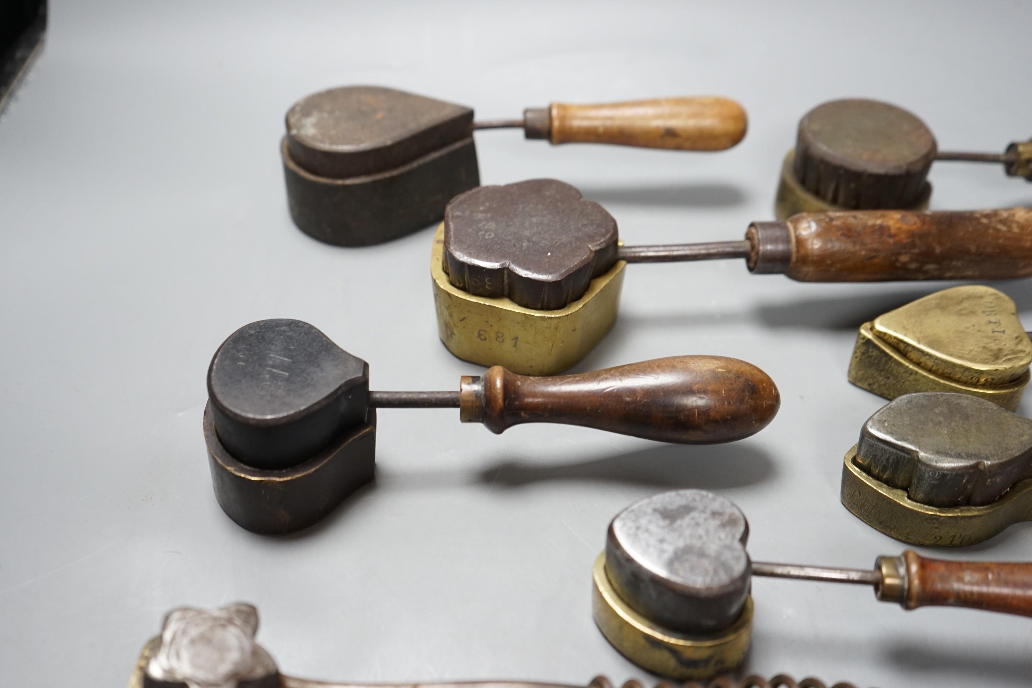 A collection of eight 19th century cast metal moulds for possibly hand embossing silk